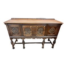 an old wooden sideboard with carvings on it