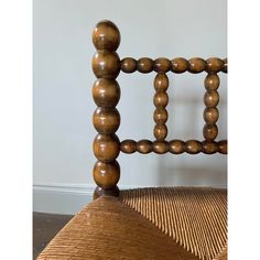 an old chair with wooden beads on the back