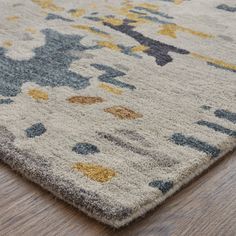 an area rug on the floor that has been made with various colors and shapes in it