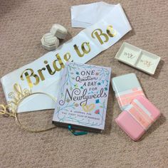 the bride to be book is laying on the floor next to some other wedding accessories