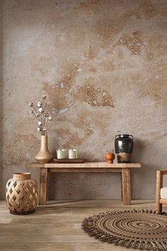 a wooden table sitting on top of a hard wood floor next to a vase filled with flowers