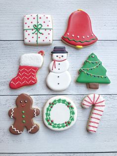 decorated christmas cookies on a white wooden table