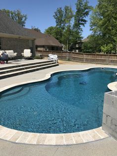 an empty swimming pool with steps leading up to the back door and stairs in front of it