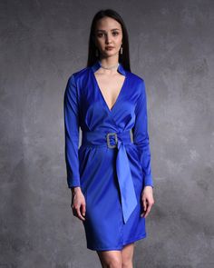 Embrace timeless elegance with this Blue Satin Long Sleeve Wrap Dress, a show-stopping piece designed for women who love to make a statement. Made from luxurious satin fabric and featuring a dazzling rhinestone buckle belt, this mini dress is ideal for cocktail parties, formal evenings, and special occasions. Its sleek, flattering design ensures you'll turn heads wherever you go. ❤️🔥 🌟 Unique Features: ✨Sleek Satin Fabric: The smooth, lustrous satin gives this dress a touch of luxury that's perfect for evening wear. ✨Glamorous Rhinestone Buckle: The rhinestone belt cinches the waist, creating a flattering hourglass silhouette and adding a sparkling detail that catches the light beautifully. ✨Long Sleeves with Wrap Front: Designed to elongate the arms and offer a sophisticated, tailored f Satin Wrap Dress, Hourglass Silhouette, Long Sleeve Wrap Dress, Satin Long Sleeve, Rhinestone Belt, Cocktail Parties, Mini Dresses For Women, Unique Features, Blue Satin