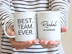 two women holding coffee mugs with the words best team ever and rachel on them