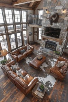 a living room filled with furniture and a fire place in front of a stone fireplace