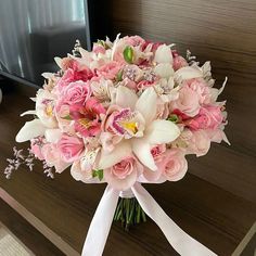 a bridal bouquet with pink and white flowers