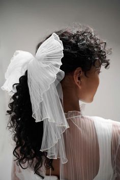 Pleated Tulle Hair Bow by TEMPÊTE | Modern Bridal Brand | Based in Canada | Ship Worldwide. Looking for an ethereal nod to make your wedding day unique to you? Our Pleated Tulle Hair Bow makes a loud statement for the daring bride looking for layers of tulle alongside a dramatic wedding dress. Perfect for bachelorettes, engagement dinners, after party, you name it! Shop Now. bridal bow tie, modern bridal bow, wedding accessories, black bride hairstyle, bridal bow detail, bridal hair bow