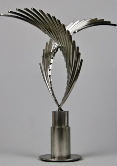 a metal sculpture is shown on a stand