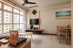 a living room filled with furniture and a flat screen tv on top of a wooden table