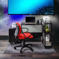 an office desk with a computer and printer on it in front of a flat screen tv