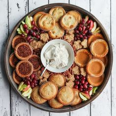 a platter filled with pies, crackers and fruit