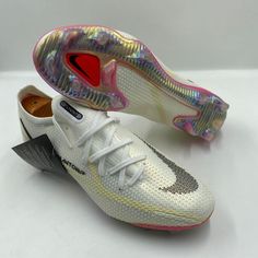 a pair of white shoes with holographics on the upper part of them