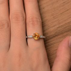 It is a natural citrine ring. The main stone is 7mm*7mm round cut, weight about 1.40 carats. The basic metal is sterling silver and plated with rhodium. To change the metal to a solid gold (white/rose) or platinum is also available, please ask for a quotation if you want. You can also go to my shop Home for more elegant rings: https://www.etsy.com/shop/godjewelry?ref=hdr_shop_menu Peridot is August birthstone Customization is always welcome and please feel free to contact with me if you have any Orange Round Jewelry With Brilliant Cut, Yellow Sapphire Ring With Round Cut Gemstone, Yellow Sapphire Gemstone Rings, Citrine Rings With Accent Stones, Citrine Rings With Accent Stones Round Cut, Citrine Gemstone Ring With Round Cut, Citrine Promise Ring Jewelry With Center Stone, Fine Jewelry Yellow Sapphire Round Ring, Citrine Center Stone Promise Ring