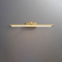 a wall mounted light on the side of a gray wall with a white back ground