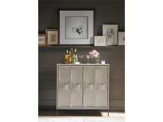 a sideboard with wine glasses and bottles on it