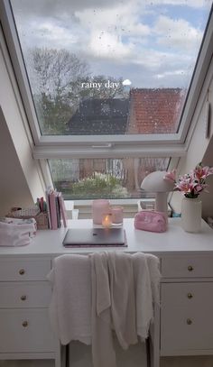 a room with a large window and white furniture