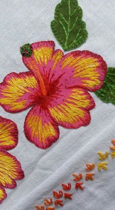 an embroidered piece of cloth with flowers on it