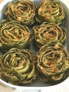 there are many artichokes in the dish on the table and ready to be eaten