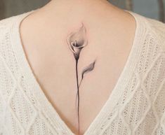 a woman with a flower tattoo on her back