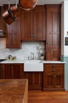 a kitchen with wooden cabinets and white counter tops