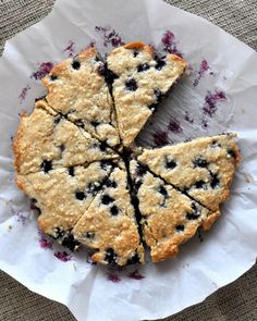 blueberry scones cut in half on a piece of parchment paper