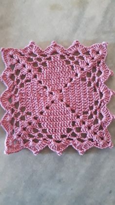 pink crocheted doily on the ground