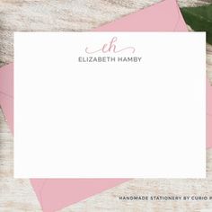 a pink envelope with the name elizabeth hamby on it and some leaves around it