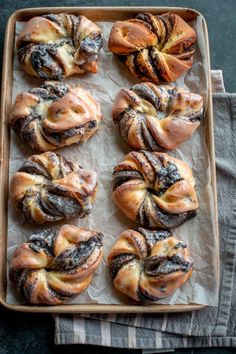 a tray filled with different types of pastries on top of a table next to a napkin