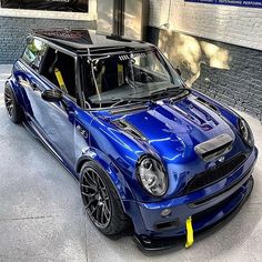 a blue car parked in front of a building