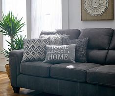 a living room with a gray couch and pillows