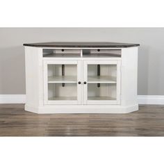 a white entertainment center with two glass doors