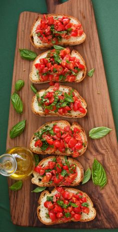 several slices of bread with tomatoes and basil on them