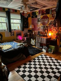 a bedroom with a checkered rug and lots of clutter