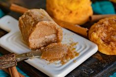 a white plate topped with food next to cinnamon sticks and doughnuts on top of a wooden table