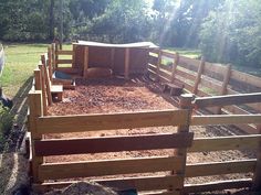 a fenced in area with some animals inside of it and dirt on the ground