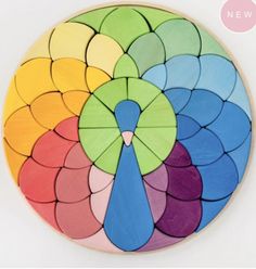 a multicolored circular wooden puzzle on a white surface