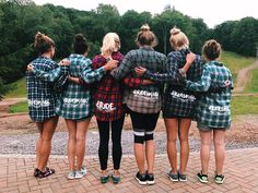 a group of young women standing next to each other on top of a brick walkway