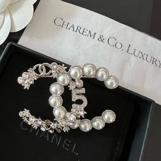 Nwt! Rare! Hard To Come By! Super Beautiful Chanel 23p Cc Logo Signature Silver Crystal Pearl Brooch. This Is The Statement Piece That Will Make You Stand Out On Any Outfit Brand New Boutique Fresh Condition Comes With Full Set W/Tag, & Receipt (Sensitive Info Omitted) Listed Price Is Firm! No Offer Will Be Accepted. Poshmark Will Authenticate Chanel Brooch Outfit, Chanel Jewellery, Chanel Flower, Chanel Lover, Ombre Prom Dresses, Classic Chanel, Chanel Brooch, Chanel Box, Chanel Brand