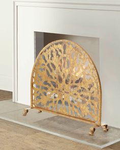 a fireplace screen sitting on top of a hard wood floor