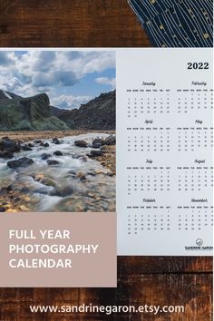 a calendar with the words full year photography calendar on it, next to an image of a river and mountains