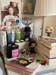 a white desk topped with lots of books and toys