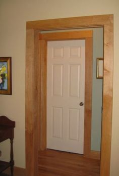 a white door in a room next to a table