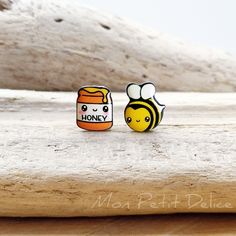 two small rings with bees and honey on them