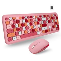 a pink computer keyboard and mouse on a pink background