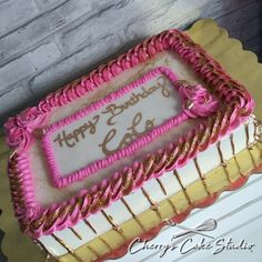 a birthday cake with pink and gold frosting