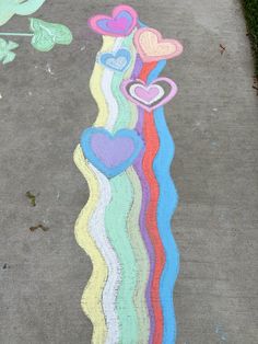 the sidewalk has been decorated with pastel hearts and rainbows on it for valentine's day