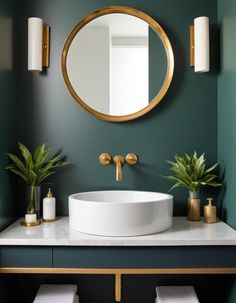 a white sink sitting under a round mirror on top of a counter next to two potted plants