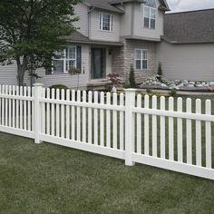 a white picket fence in front of a house