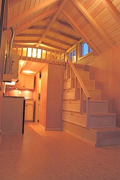 the inside of a house with stairs leading up to it